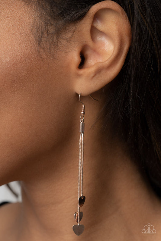 Higher Love Rose Gold Earring - Paparazzi Accessories  Shiny rose gold heart charms delicately trickle from varying lengths of rounded rose gold snake chains, resulting in a flirtatious tassel. Earring attaches to a standard fishhook fitting.  Sold as one pair of earrings.