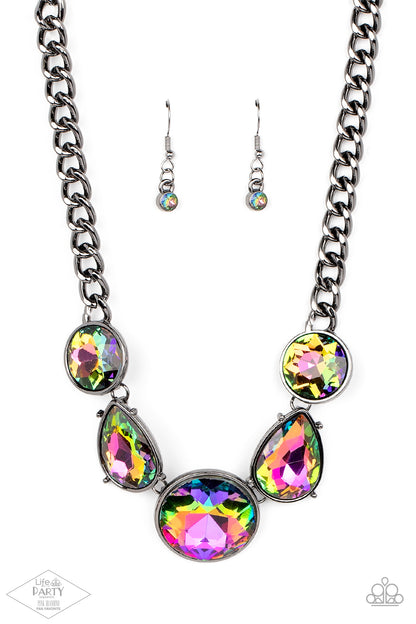 All The Worlds My Stage Multi Necklace - Paparazzi Accessories  Infused with heavy gunmetal chain, an exaggerated display of round and teardrop-shaped oil spill rhinestones connects below the collar for a blinding look. Features an adjustable clasp closure.  Sold as one individual necklace. Includes one pair of matching earrings. This Fan Favorite is back in the spotlight at the request of our 2021 Life of the Party member with Pink Diamond Access, Kathy D.