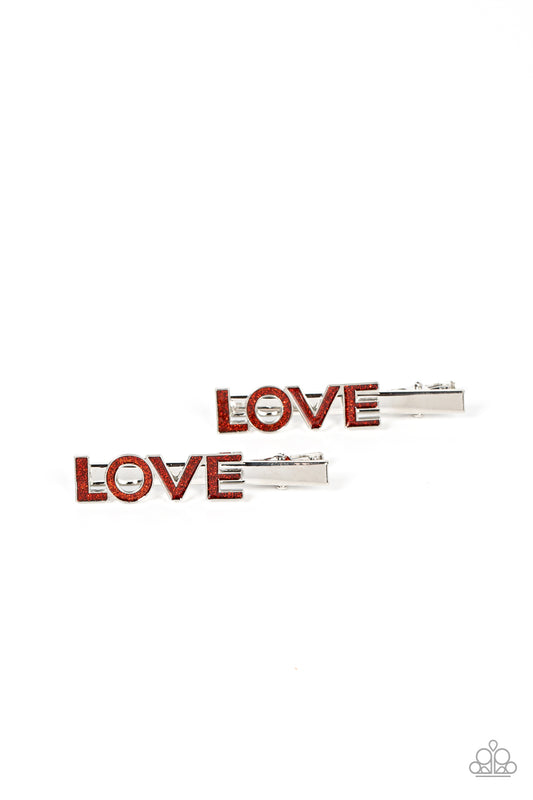 Adored Adornment Red Love Hair Clip - Paparazzi Accessories  Featuring a glittery red finish, the word, "Love," is spelled across the front of a pair of silver hair clips for a colorfully charming look. Features standard hair clips on the back.  Sold as one pair of hair clips.