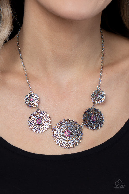Marigold Meadows Pink Necklace - Paparazzi Accessories  Infused with a whimsical mandala-like motif, tactile silver petals bloom from pink rhinestone dotted centers below the collar. The mismatched silver flowers gradually increase in size, exaggerating the eye-catching details. Features an adjustable clasp closure.  Sold as one individual necklace. Includes one pair of matching earrings.