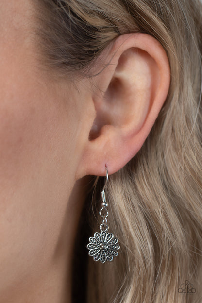Marigold Meadows Pink Necklace - Paparazzi Accessories  Infused with a whimsical mandala-like motif, tactile silver petals bloom from pink rhinestone dotted centers below the collar. The mismatched silver flowers gradually increase in size, exaggerating the eye-catching details. Features an adjustable clasp closure.  Sold as one individual necklace. Includes one pair of matching earrings.