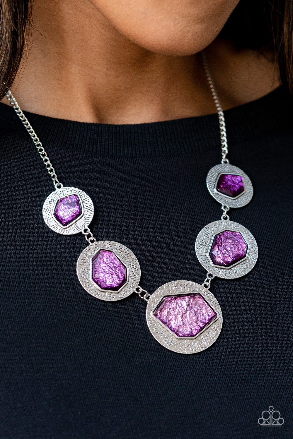 Raw Charisma Purple Necklace - Paparazzi Accessories  Featuring a refracted shimmer, asymmetrical, glassy purple gems sparkle atop textured silver discs as they delicately link into an edgy statement piece below the collar. Features an adjustable clasp closure.  Sold as one individual necklace. Includes one pair of matching earrings.