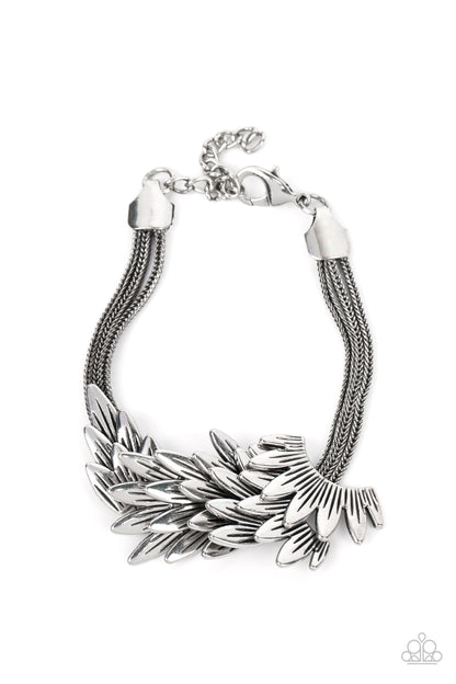 BOA and Arrow Silver Bracelet - Paparazzi Accessories  Feathery silver frames delicately overlap across the center of the wrist, creating a boa-like centerpiece atop rows of rustic silver chains. Features an adjustable clasp closure.  Sold as one individual bracelet.