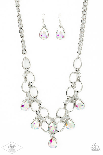 Show-Stopping Shimmer Multi Necklace - Paparazzi Accessories  Joined by dainty silver links, two rows of dramatic silver chain layer below the collar in a fierce fashion. Iridescent teardrop gems drip from the glistening layers, adding a timeless shimmer to the show-stopping piece. Features an adjustable clasp closure. Includes one pair of matching earrings. This Fan Favorite is back in the spotlight at the request of our 2021 Life of the Party member with Pink Diamond Access, Karla N.