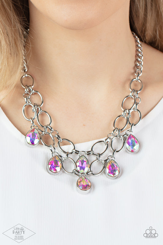 Show-Stopping Shimmer Multi Necklace - Paparazzi Accessories  Joined by dainty silver links, two rows of dramatic silver chain layer below the collar in a fierce fashion. Iridescent teardrop gems drip from the glistening layers, adding a timeless shimmer to the show-stopping piece. Features an adjustable clasp closure. Includes one pair of matching earrings. This Fan Favorite is back in the spotlight at the request of our 2021 Life of the Party member with Pink Diamond Access, Karla N.