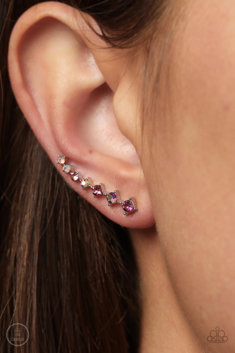 STARLIGHT Show Pink Ear Crawler Earring - Paparazzi Accessories  An iridescent spectrum of dainty pink rhinestones gradually increase in intensity as they climb the ear for a stellar fashion. Features an extended post fitting that climbs the back of the ear and can be pressed together for a more secure fit.  Sold as one pair of ear crawlers.