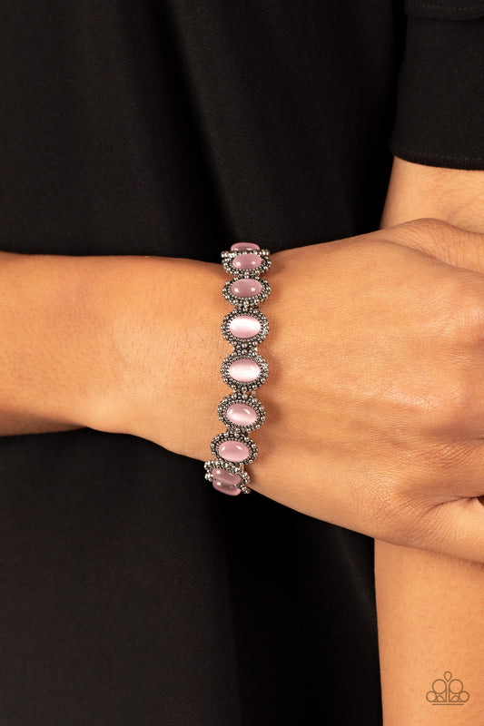Sweet Oblivion Pink Bracelet - Paparazzi Accessories  Bordered in dainty silver studs, pairs of pink cat's eye stones are threaded along stretchy bands around the wrist for a dreamy fashion.  Sold as one individual bracelet.  P9WH-PKXX-276XX