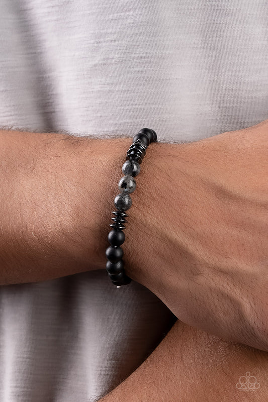 Urban Therapy Black Beaded Bracelet - Paparazzi Accessories   Sections of polished black stones, shiny gunmetal accents, and speckled black stones are threaded along stretchy bands around the wrist for an earthy edge.  Sold as one individual bracelet.