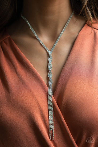 Impressively Icy White Necklace - Paparazzi Accessories  Silvery ribbons of glassy white rhinestones loop around the neck and delicately twist into an icy tassel down the chest. Features an adjustable clasp closure.  Sold as one individual necklace. Includes one pair of matching earrings.