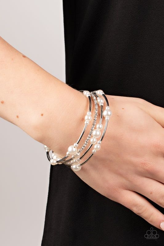 Marina Masterpiece White Bracelet - Paparazzi Accessories  Bubbly white pearls, cylindrical silver beads, and glassy white rhinestones are threaded along a coiled wire, resulting in a timeless infinity wrap bracelet around the wrist.  Sold as one individual bracelet.