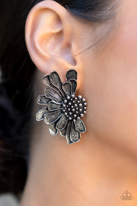 Farmstead Meadow Silver Earring - Paparazzi Accessories  Imperfect silver petals bloom from a studded center, layering into a rustic half blossom for a whimsical flair. Earring attaches to a standard post fitting.  Sold as one pair of post earrings.
