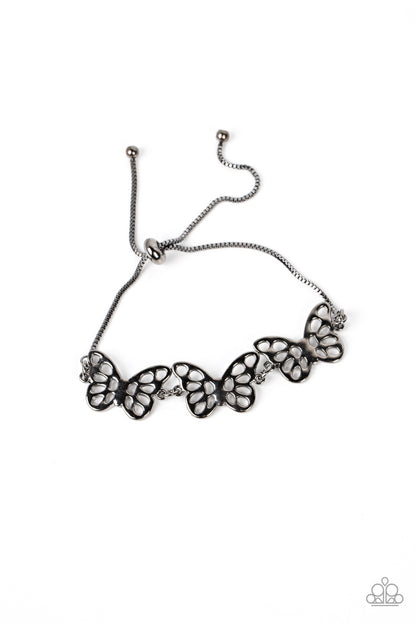 Put a WING on It Black Bracelet - Paparazzi Accessories  Featuring airy stenciled cutouts, three gunmetal butterflies delicately connect at the center of a gunmetal box chain for a whimsical fashion. Features an adjustable sliding bead closure.  Sold as one individual bracelet.