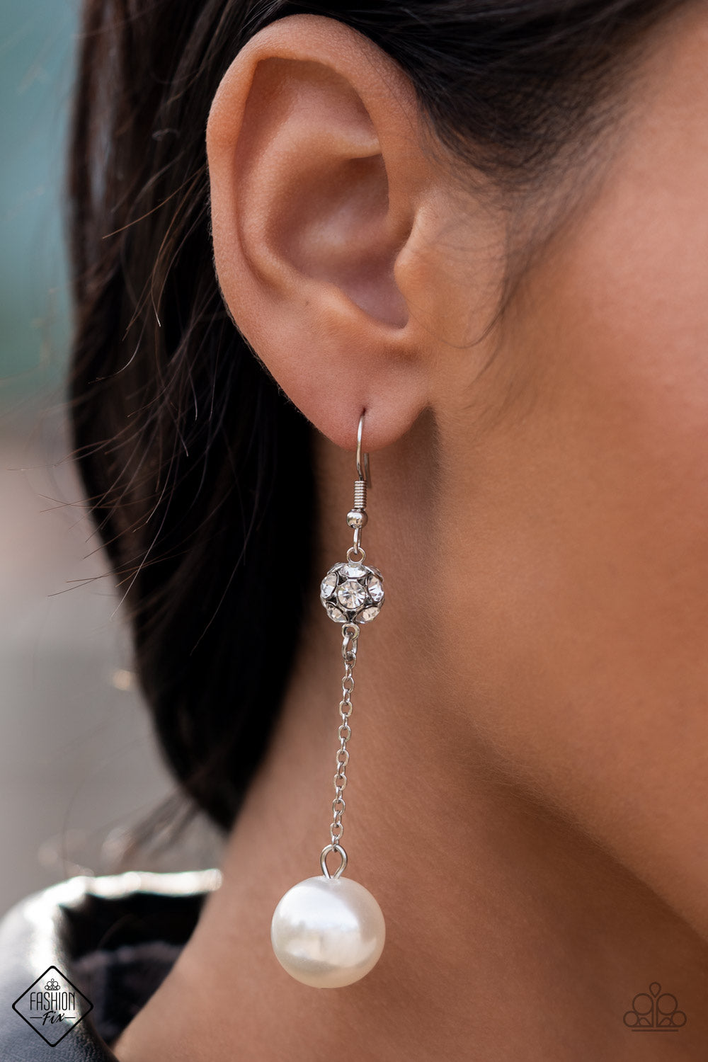Nautical Nostalgia White Earring - Paparazzi Accessories  A lusciously oversized pearl is suspended from a dainty silver chain that delicately sways from a brilliant cluster of white rhinestones, making a glamorously elegant lure. Earring attaches to a standard fishhook fitting.  Sold as one pair of earrings.