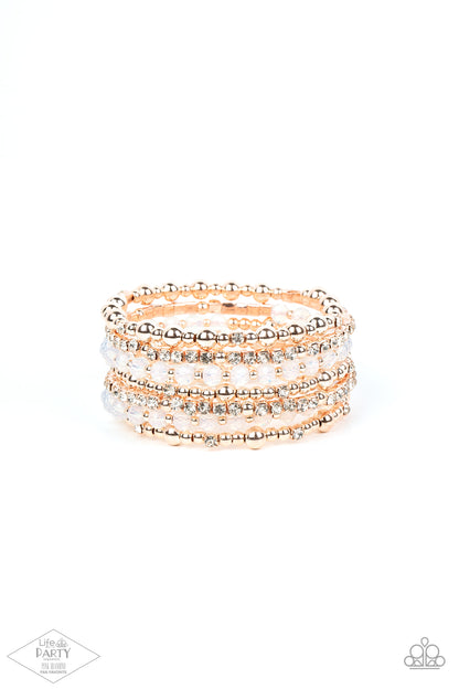 ICE Knowing You Rose Gold Bracelet - Paparazzi Accessories  An icy collection of rose gold beads, rose gold cubes, opaque crystals, and glassy white rhinestones are threaded along a coiled wire, creating a blinding infinity wrap style bracelet around the wrist.  Sold as one individual bracelet. This Fan Favorite is back in the spotlight at the request of our 2021 Life of the Party member with Pink Diamond Access, Crystal R.