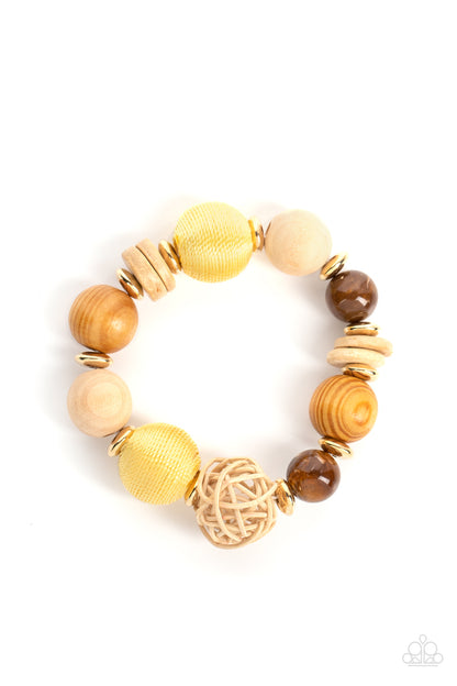 Happily Homespun Yellow Bracelet - Paparazzi Accessories  Infused with a single rattan sphere, a mismatched collection of oversized wooden beads, yellow thread wrapped beads, dainty gold accents, and glassy brown beads are threaded along stretchy bands around the wrist for a homespun vibe.  Sold as one individual bracelet.