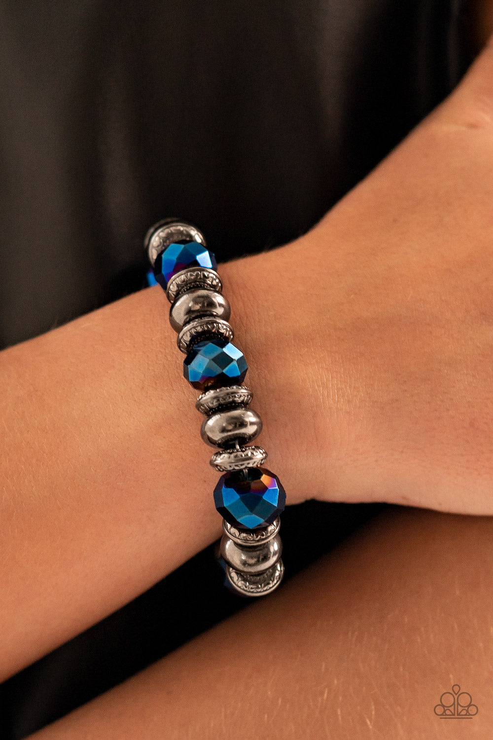 Power Pose Blue Bracelet - Paparazzi Accessories  An oversized assortment of textured gunmetal rings, smooth gunmetal beads, and metallic blue crystal-like beads are threaded along stretchy bands around the wrist for a glitzy finish.  Sold as one individual bracelet.  Get The Complete Look! Necklace: "Interstellar Influencer - Blue" (Sold Separately)