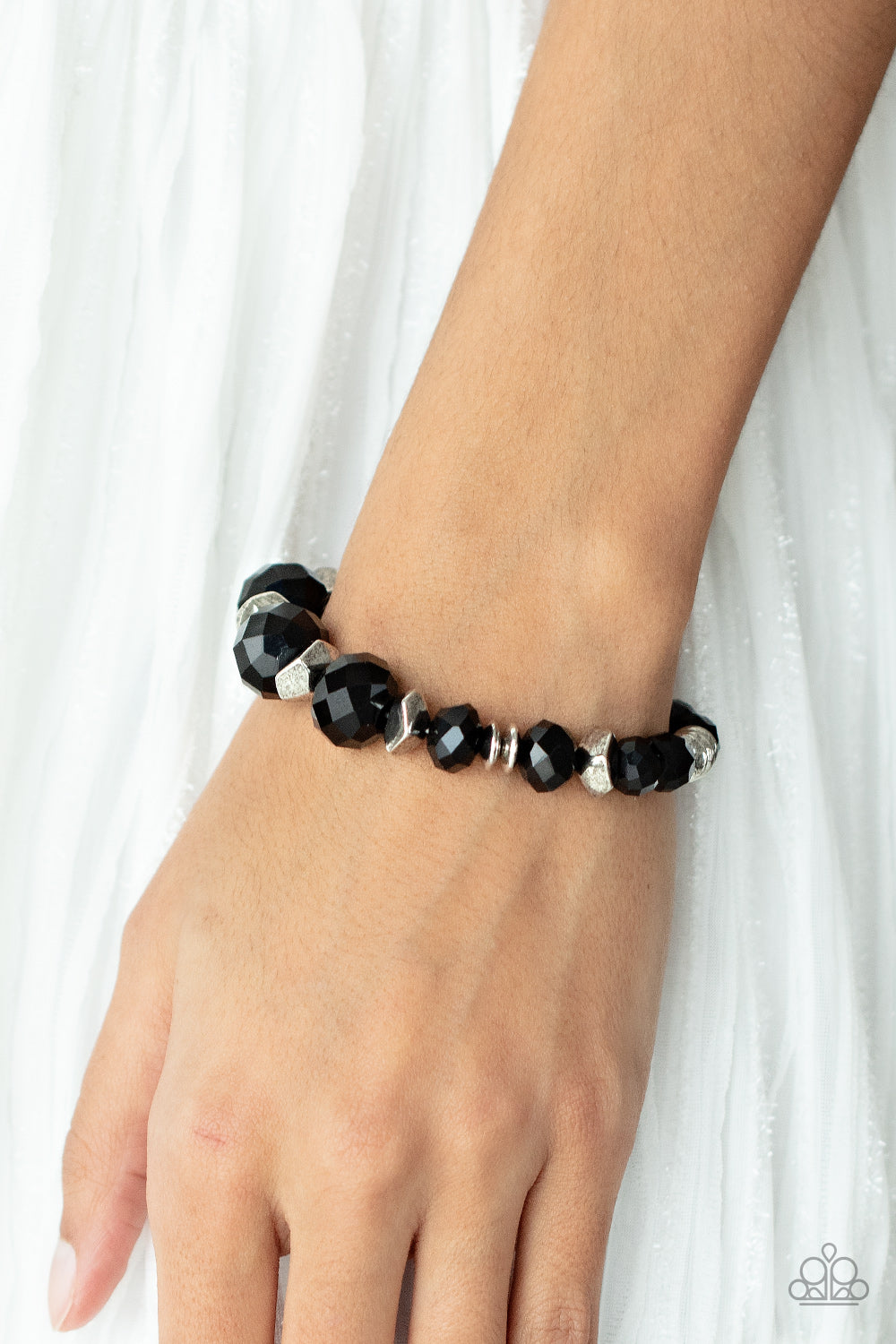 Astral Auras Black Bracelet - Paparazzi Accessories  Separated by silver discs and faceted silver accents, faceted black crystal-like gems are threaded along stretchy bands around the wrist for a stellar statement.  Sold as one individual bracelet.  Get The Complete Look! Necklace: "Cosmic Cadence - Black" (Sold Separately)