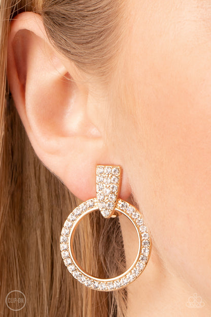 Sparkle at Your Service Gold Clip-On Earring - Paparazzi Accessories  Encrusted in glassy white rhinestones, a gold hoop attaches to a triangular gold fitting for a classic sparkle. Earring attaches to a standard clip-on fitting.  Sold as one pair of clip-on earrings.