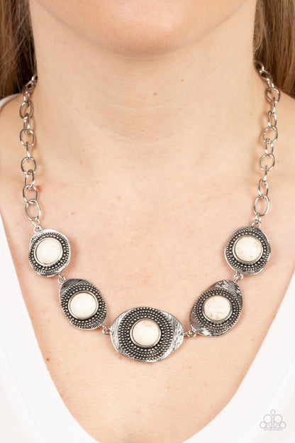 Homestead Harmony White Necklace - Paparazzi Accessories Item #P2SE-WTXX-282XX Refreshing white stones dot the centers of wavy irregular-shaped frames. Embellished with studded and etched feathery texture, the rustic frames create an earthy artisanal display below the collar. Features an adjustable clasp closure.  Sold as one individual necklace. Includes one pair of matching earrings.