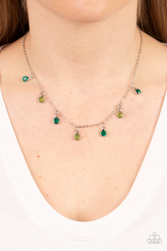 Carefree Charmer Green Necklace - Paparazzi Accessories  Encased in sleek silver fittings, a dainty collection of glassy green and light green gems twinkles along a dainty silver chain below the collar, creating a colorful fringe. Features an adjustable clasp closure.  Sold as one individual necklace. Includes one pair of matching earrings.