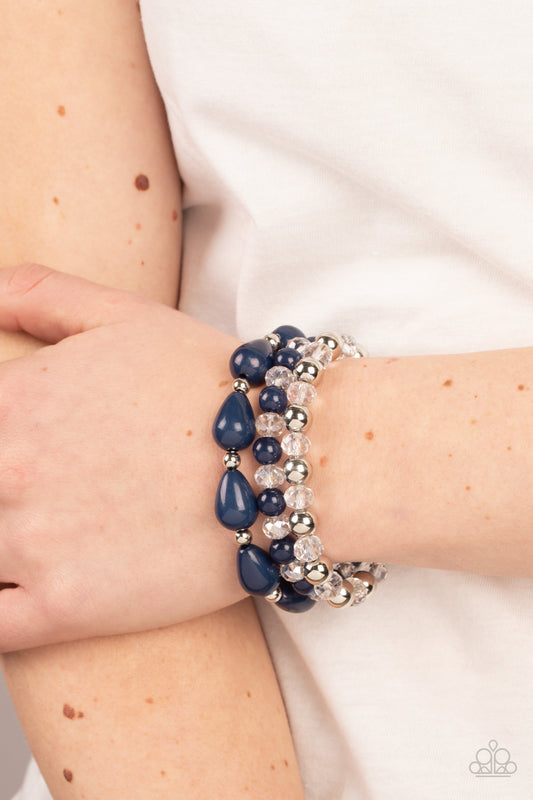 Beachside Brunch Blue Bracelet - Paparazzi Accessories  A whimsical assortment of crystal-like beads, silver beads, opaque navy beads, and navy teardrop beads are threaded along stretchy bands around the wrist, resulting in colorful layers.  Sold as one set of three bracelets.