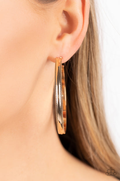 Monochromatic Magnetism Gold Hoop Earring - Paparazzi Accessories   Bordered in gritty ribbons of texture, a flat gold bar curves into an oversized hoop for an intense industrial statement. Earring attaches to a standard post fitting. Hoop measures approximately 2 1/4" in diameter.  Sold as one pair of hoop earrings.