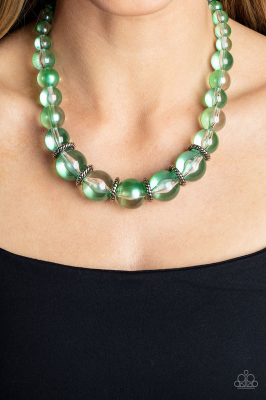 Marina Mirage Green Necklace - Paparazzi Accessories  Lightly brushed in a pearly green shimmer, glassy translucent beads gradually increase in size as they are threaded along an invisible wire below the collar. Textured silver rings separate the largest beads, adding grounding accents to the opalescent display. Features an adjustable clasp closure.  Sold as one individual necklace. Includes one pair of matching earrings.