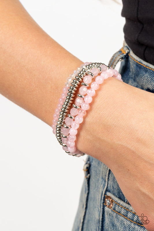 Destination Dreamscape Pink Bracelet - Paparazzi Accessories  A mismatched collection of opaque and crystal-like Gossamer Pink beads intermix with silver accents and white crystal-like beads along stretchy bands around the wrist, creating colorful layers.  Sold as one set of four bracelets.