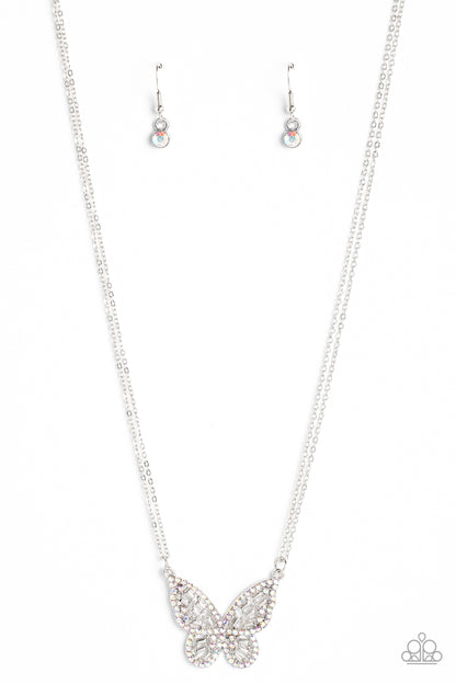 Baroque Butterfly Multi Necklace - Paparazzi Accessories  Bordered in iridescent rhinestones, an airy silver butterfly is dotted in dainty iridescent rhinestones and shiny silver emerald-like accents as it flutters from two chains below the collar for an enchanting fashion. Features an adjustable clasp closure. Due to its prismatic palette, color may vary.  Sold as one individual necklace. Includes one pair of matching earrings.  Get The Complete Look! Bracelet: "Butterfly Bella - Multi" (Sold Separately)