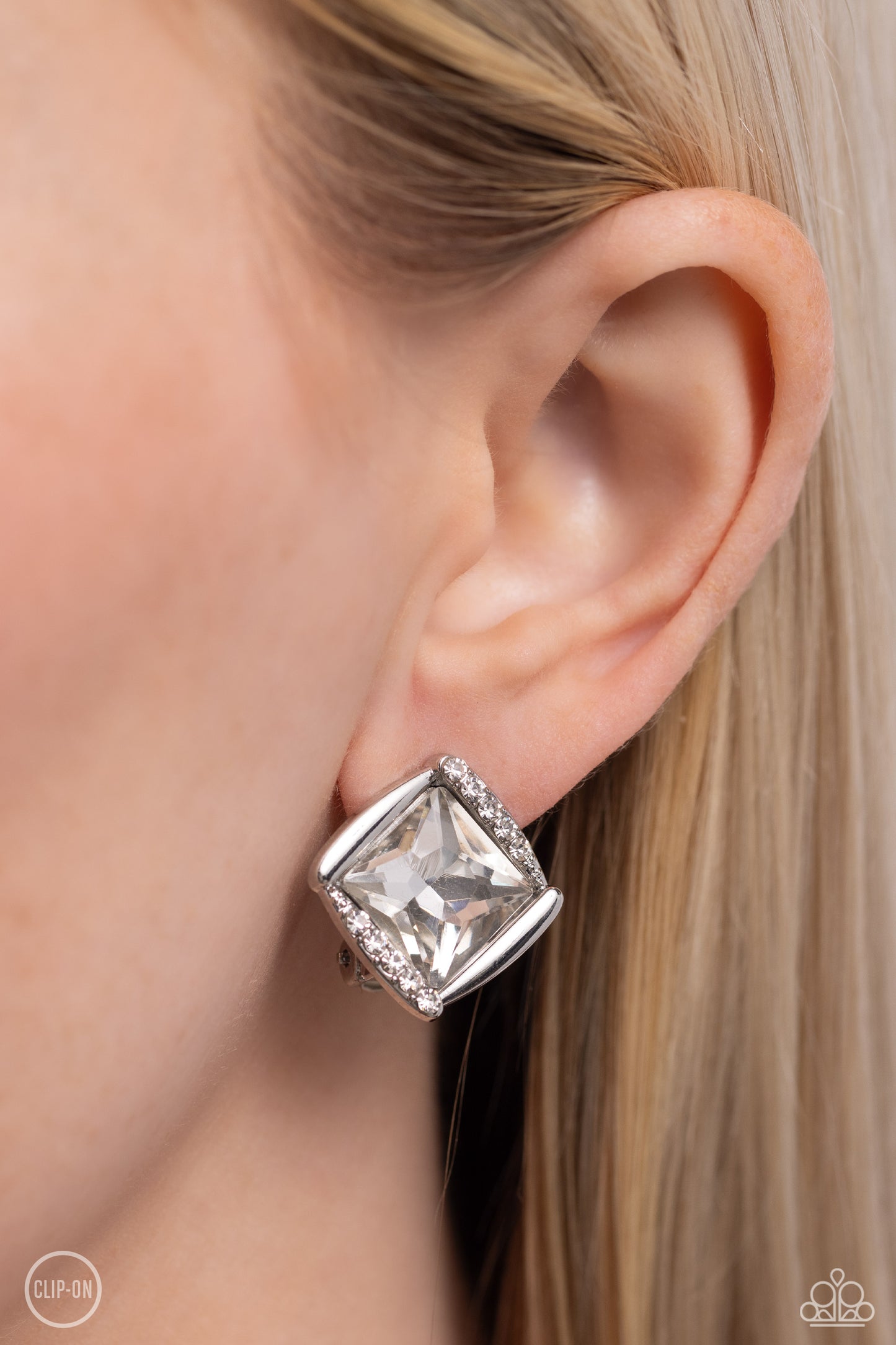 Sparkle Squared White Rhinestone Clip-On Earring - Paparazzi Accessories  Shiny silver bars gently overlap with white rhinestone encrusted silver bars around a square cut white rhinestone, resulting in a refined radiance. Earring attaches to a standard clip-on fitting.  Sold as one pair of clip-on earrings.  P5CO-WTXX-136XX