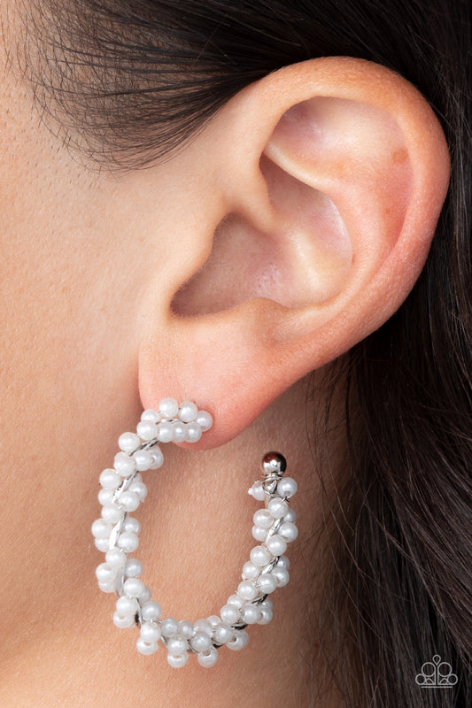 Yacht Royale White Pearl Hoop Earring - Paparazzi Accessories  A dainty strand of white pearls is delicately wrapped around a classic silver hoop, creating bubbly refinement. Earring attaches to a standard post fitting. Hoop measures approximately 1 1/2" in diameter.  Sold as one pair of hoop earrings.  P5HO-WTXX-129XX