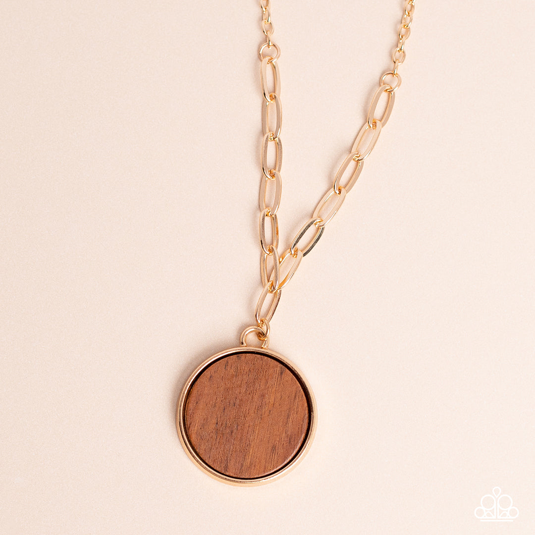 WOODnt Dream of It Gold Necklace - Paparazzi Accessories  A circular piece of wood is nestled inside a simple gold fitting along a mismatched gold chain, creating an earthy pendant below the collar. Features an adjustable clasp closure.  Sold as one individual necklace. Includes one pair of matching earrings.  New Kit Sku:  P2SE-GDXX-115XX