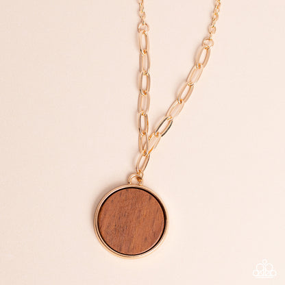 WOODnt Dream of It Gold Necklace - Paparazzi Accessories  A circular piece of wood is nestled inside a simple gold fitting along a mismatched gold chain, creating an earthy pendant below the collar. Features an adjustable clasp closure.  Sold as one individual necklace. Includes one pair of matching earrings.  New Kit Sku:  P2SE-GDXX-115XX