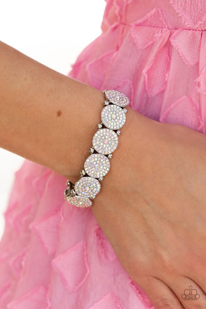 Palace Intrigue Multi Bracelet - Paparazzi Accessories  Separated by pairs of silver beads, iridescent rhinestone encrusted silver frames glitter along stretchy bands around the wrist for an out-of-this-world sparkle. Due to its prismatic palette, color may vary.  Sold as one individual bracelet.