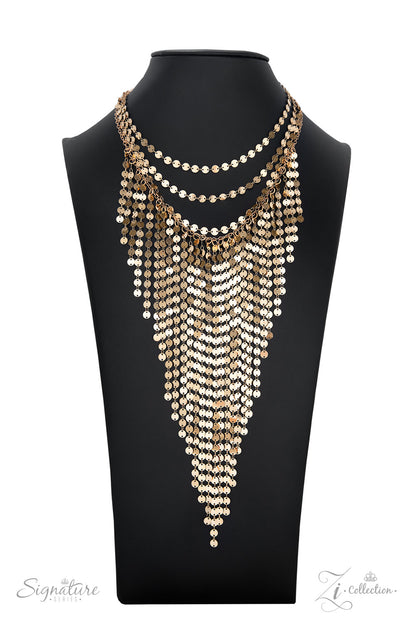 The Suz 2022 Zi Collection Necklace - Paparazzi Accessories  A seemingly infinite collection of dainty gold discs flickers and flashes as they catch the light, draping into four shimmery rows down the chest. Twinkly tassels of matching gold discs stream out from the bottom of the lowermost row, tapering into a hypnotic fringe that glints and glimmers, creating its own spotlight. Features an adjustable clasp closure.  Sold as one individual necklace. Includes one pair of matching earrings.