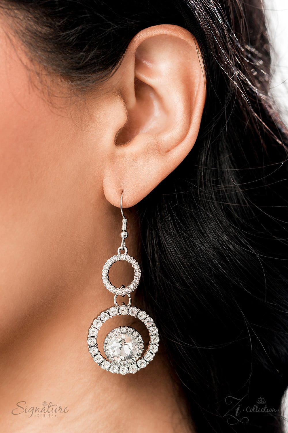 Dozens of circular silver frames are encrusted in shimmery white rhinestones and link together to create a dizzying display along the collar. The frames gradually increase in size as they lead to the center, boldly showcasing their stunning detail. Solitaire white rhinestones, wrapped in a border of dainty sparkling accents, are sporadically sprinkled throughout the lacy canvas, with square-cut rhinestones in pronged settings adding three-dimensional dazzle. Features an adjustable clasp closure.