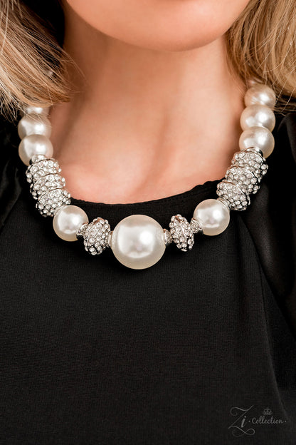 Noble 2022 Zi Collection Necklace - Paparazzi Accessories  Exaggerated white pearls gradually increase in size as they fall along the neckline, leading to a prominent centerpiece. The refined palette is complemented by shimmery silver accents, interspersed throughout the polished pearls and infused with sparkling rhinestones that scatter light in every direction. Features an adjustable clasp closure.