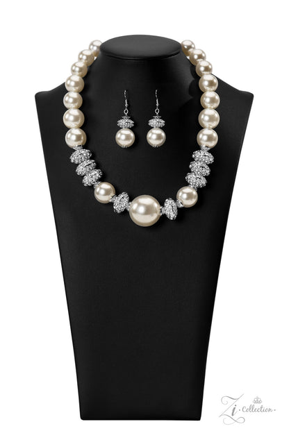 Noble 2022 Zi Collection Necklace - Paparazzi Accessories  Exaggerated white pearls gradually increase in size as they fall along the neckline, leading to a prominent centerpiece. The refined palette is complemented by shimmery silver accents, interspersed throughout the polished pearls and infused with sparkling rhinestones that scatter light in every direction. Features an adjustable clasp closure.