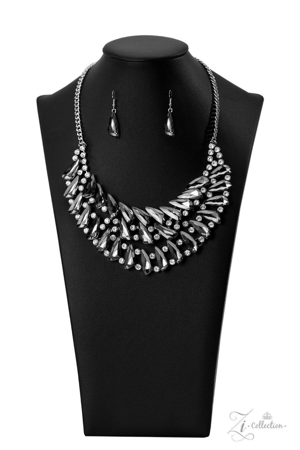Perceptive 2022 Zi Collection Necklace - Paparazzi Accessories  Smoky, triangular rhinestones are scattered along the collar in razor-sharp precision, falling into a dramatic, angular pattern. Brilliant white rhinestones are sprinkled in between the faceted, smoldering gems, adding fearless hints of sparkle to this glamorously gritty jaw-dropper. Features an adjustable clasp closure.