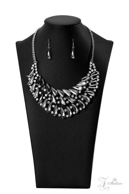 Perceptive 2022 Zi Collection Necklace - Paparazzi Accessories  Smoky, triangular rhinestones are scattered along the collar in razor-sharp precision, falling into a dramatic, angular pattern. Brilliant white rhinestones are sprinkled in between the faceted, smoldering gems, adding fearless hints of sparkle to this glamorously gritty jaw-dropper. Features an adjustable clasp closure.