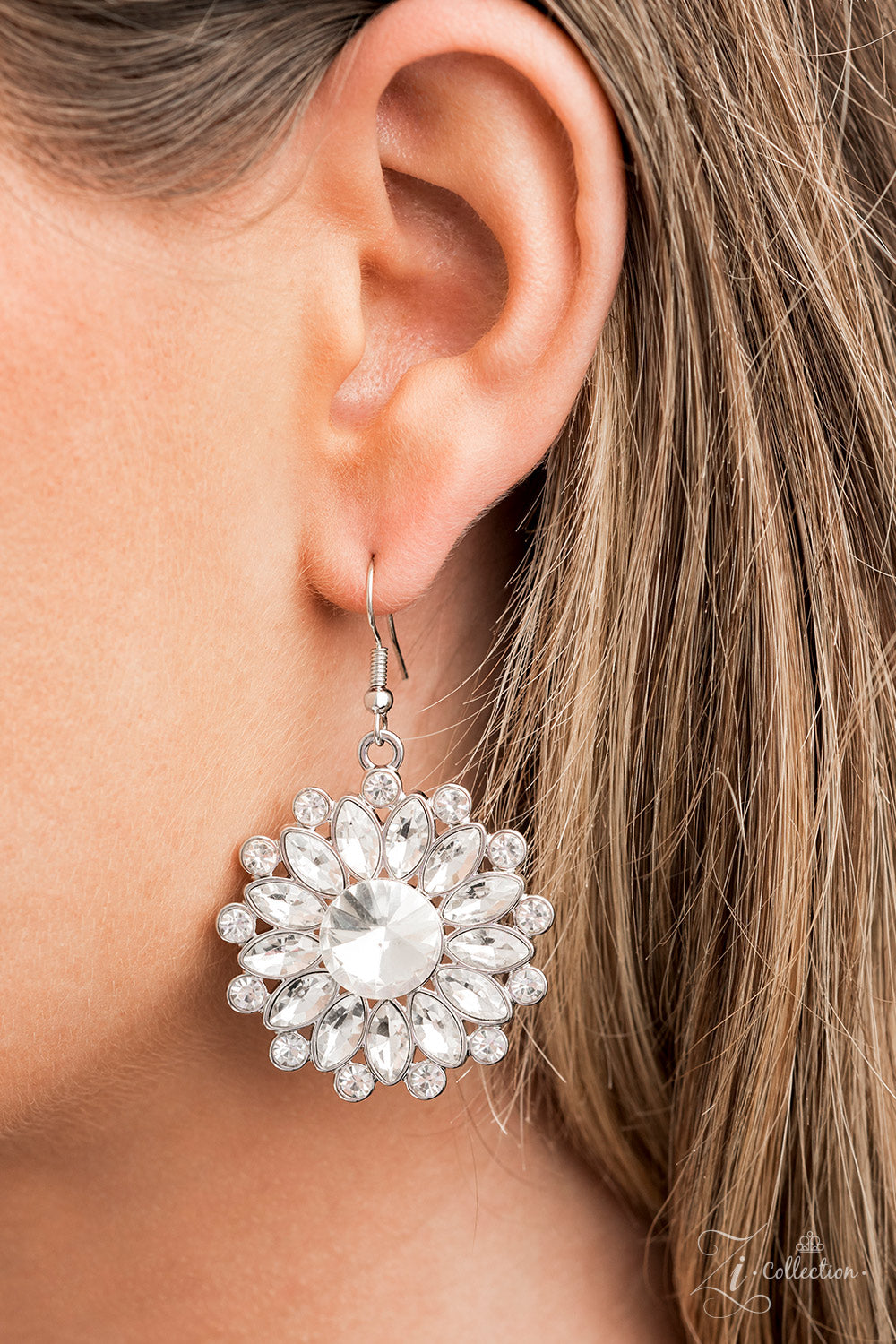 Oversized classic white rhinestones are encircled by majestic marquise-cut rhinestones in the same radiant finish, creating a collection of stunning floral frames. Smaller white rhinestones fall in between each gorgeous marquise-cut petal, magnifying the shimmer emitted by the dramatically faceted surfaces of each piece. The glittery flowers increase in size as they link together along the neckline, leading to the largest frame at the center in a twinkling finish. Features an adjustable clasp closure.