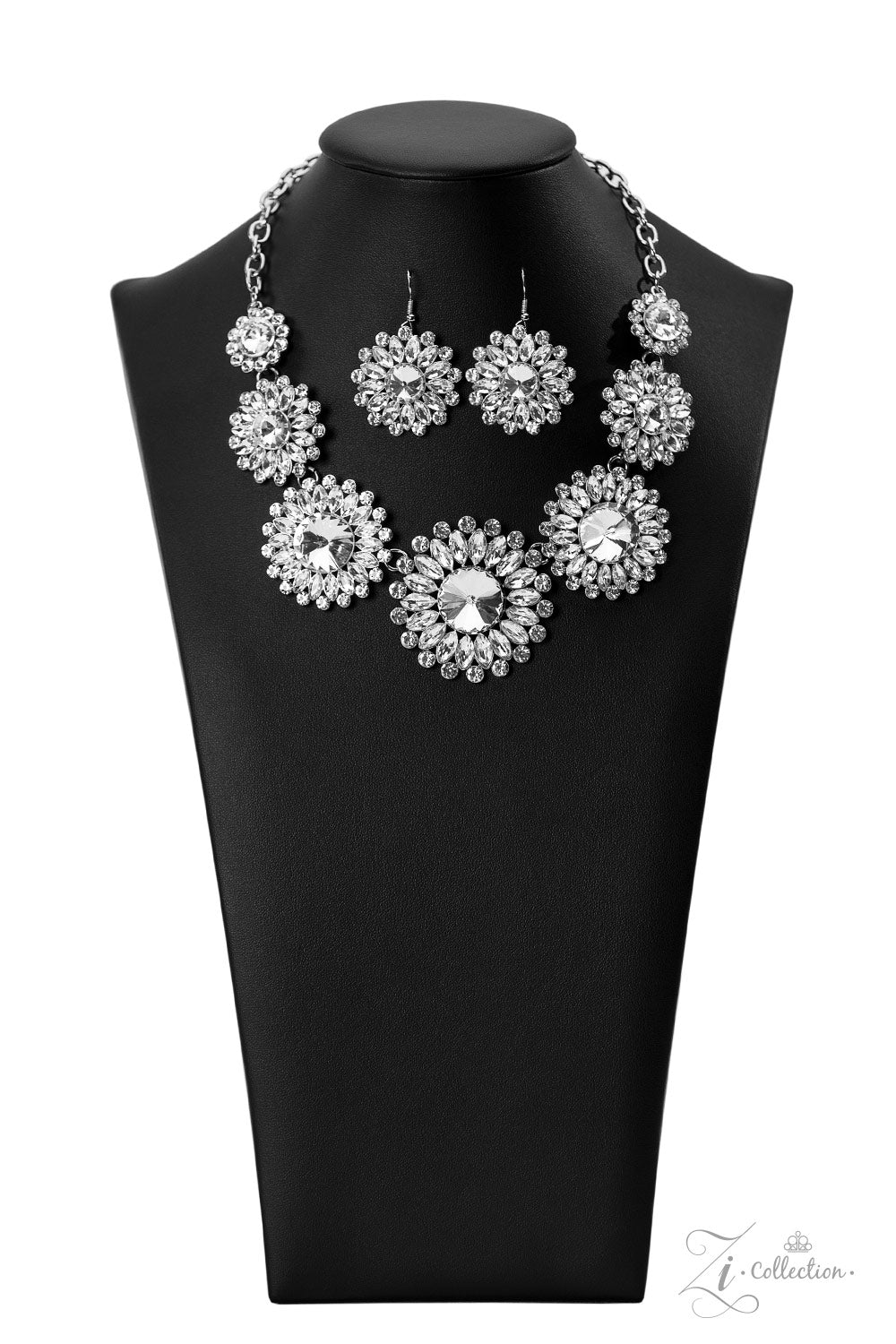 Oversized classic white rhinestones are encircled by majestic marquise-cut rhinestones in the same radiant finish, creating a collection of stunning floral frames. Smaller white rhinestones fall in between each gorgeous marquise-cut petal, magnifying the shimmer emitted by the dramatically faceted surfaces of each piece. The glittery flowers increase in size as they link together along the neckline, leading to the largest frame at the center in a twinkling finish. Features an adjustable clasp closure.