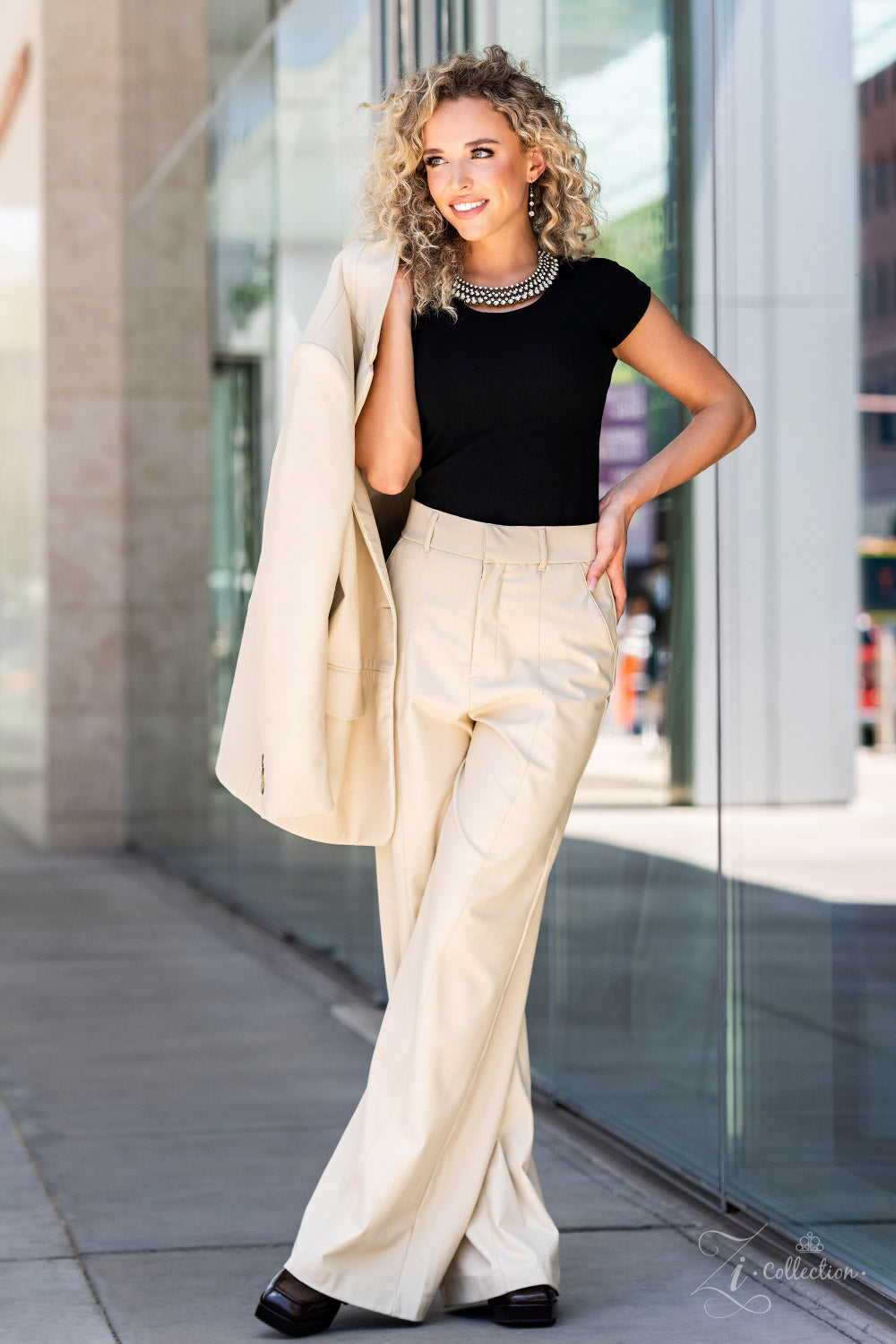 Thin bars of brass, etched in rugged linear texture and dotted with tiny brass studs, are topped by brilliant white rhinestones encased in pronged fittings. The bars are threaded along wires and separated by tiny brass beads, creating a dizzying display along the collar. The collision of glitz and grit fans out along the neckline, inviting onlookers to take a second look at the impeccable detail and dramatic sparkle. Features an adjustable clasp closure.