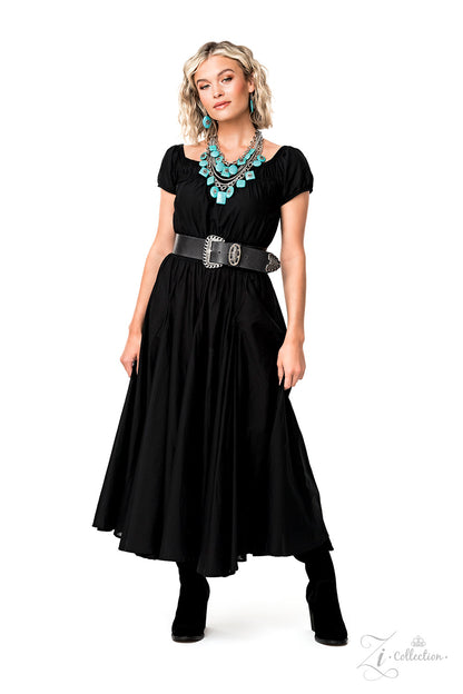 Strands of oversized silver chain links and rounded box chain in the same metallic sheen, drape into dramatic layers across the chest, creating a boisterous collision of texture. Smooth turquoise stones, chiseled into large, flat squares, circles, and rectangles, dance along the bulky silver chains, bringing vibrant splashes of color to the design. Finally, floral appliqués in an antiqued silver finish decorate the surfaces of some of the turquoise stones.