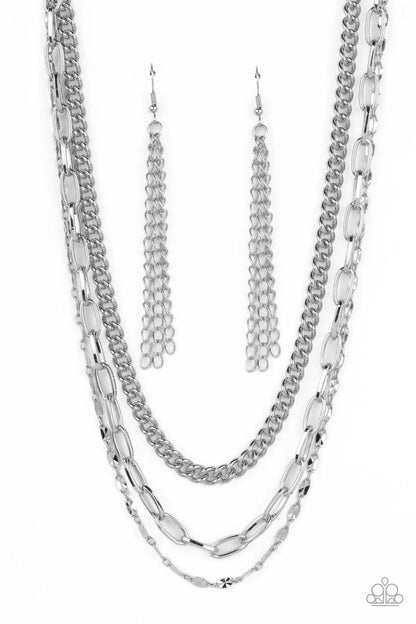 Galvanized Grit Silver Necklace - Paparazzi Accessories  Three different kinds of weighted silver chains layer down the neck to create a gritty, edgy statement piece. Features an adjustable clasp.  Sold as one individual necklace. Includes one pair of matching earrings.