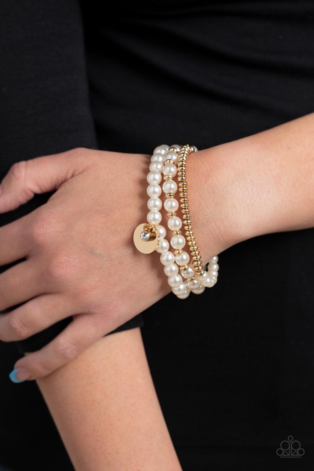Pearly Professional Gold Bracelet - Paparazzi Accessories  Classic white pearls, glistening gold beads, and a white crystal rhinestone are threaded along elastic stretchy bands, creating refined layers across the wrist.  Sold as one set of three bracelets.  P9RE-GDXX-373XX