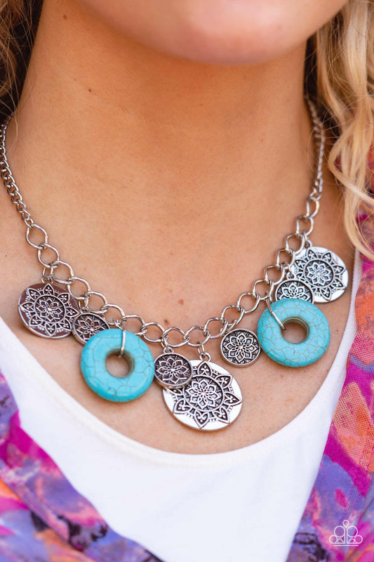 Western Zen Turquoise Necklace - Paparazzi Accessories  A collection of silver discs, embellished with intricate mandala-like designs, dances along a thick silver chain, with a pair of polished turquoise stone rings adding a pop of color to the rustic design. Features an adjustable clasp closure.  Sold as one individual necklace. Includes one pair of matching earrings.