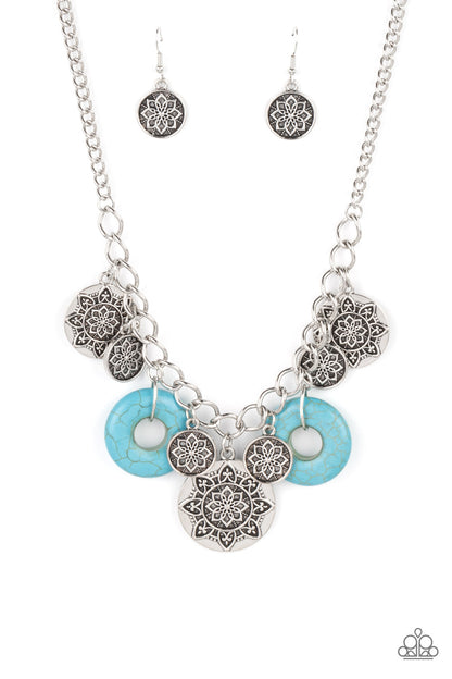 Western Zen Turquoise Necklace - Paparazzi Accessories  A collection of silver discs, embellished with intricate mandala-like designs, dances along a thick silver chain, with a pair of polished turquoise stone rings adding a pop of color to the rustic design. Features an adjustable clasp closure.  Sold as one individual necklace. Includes one pair of matching earrings.