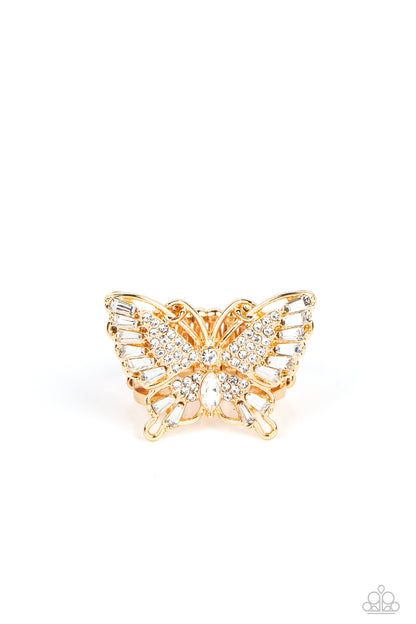 Fearless Flutter Gold Butterfly Ring - Paparazzi Accessories  Sparkling with round, teardrop, and emerald cut white rhinestones, a gold butterfly fearlessly flutters atop the finger for a statement-making finish. Features a stretchy band for a flexible fit.  Sold as one individual ring.