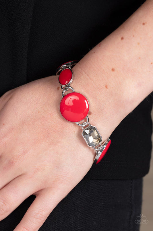 Dreamscape Dazzle Red Bracelet - Paparazzi Accessories  A rectangular sparkling smoky gem and a true red oval bead add elegance to a monochromatic collection of three oversized red circles. Set in silver frames, the whimsical collection attaches to a silver chain, for a refreshing splash of color around the wrist. Features an adjustable clasp closure.  Sold as one individual bracelet.